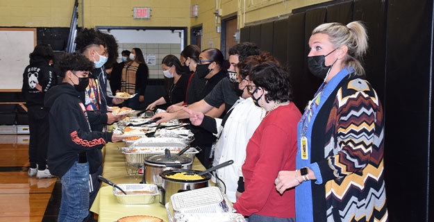 Students and Staff At Thanksgiving Feast