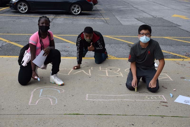 Members of the West Hempstead Middle School Dignity and Tolerance Club writing positive messages