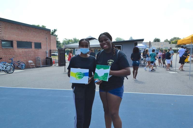 Two West Hempstead students display the artwork they created during the school district’s Community Welcome event on Aug. 27.