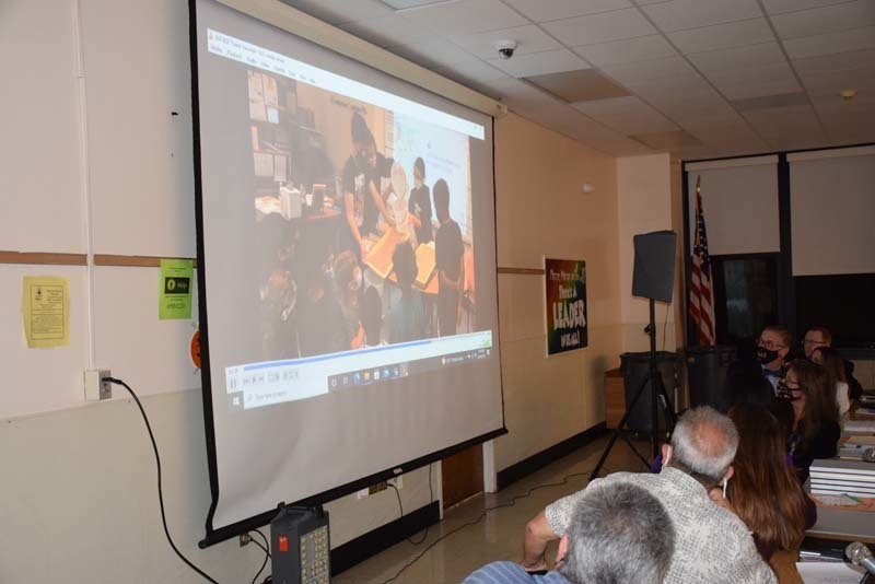 board of education watching video on the projector