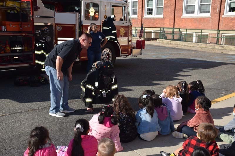 fire fighters talking to students during their presentation