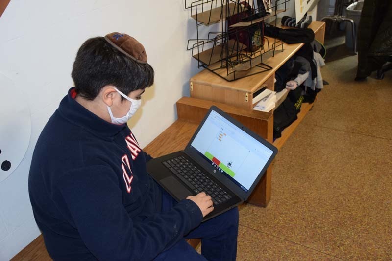 Sixth grader Yonah Lalehzari on the Computer