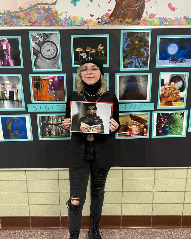 10th grader Rozlyn Rodriguez Holding Artwork