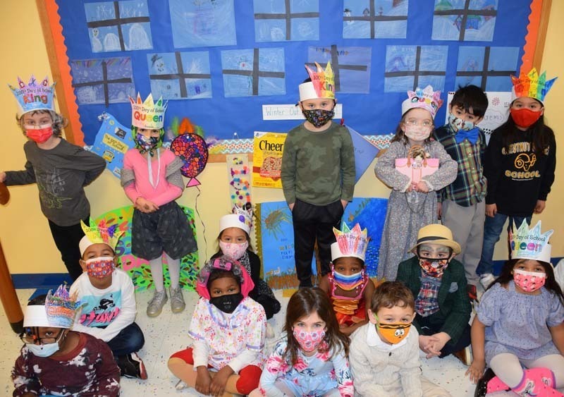 students dressed as centenarians wearing paper crowns