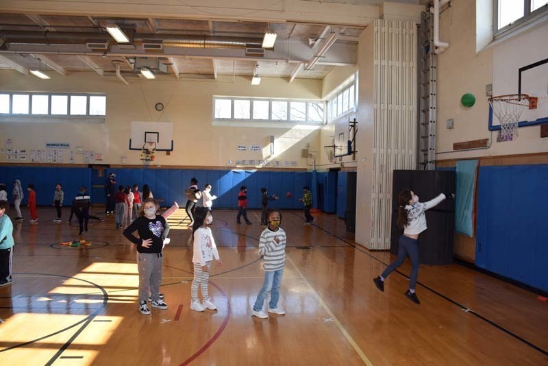 Students Playing Basketball in Gym