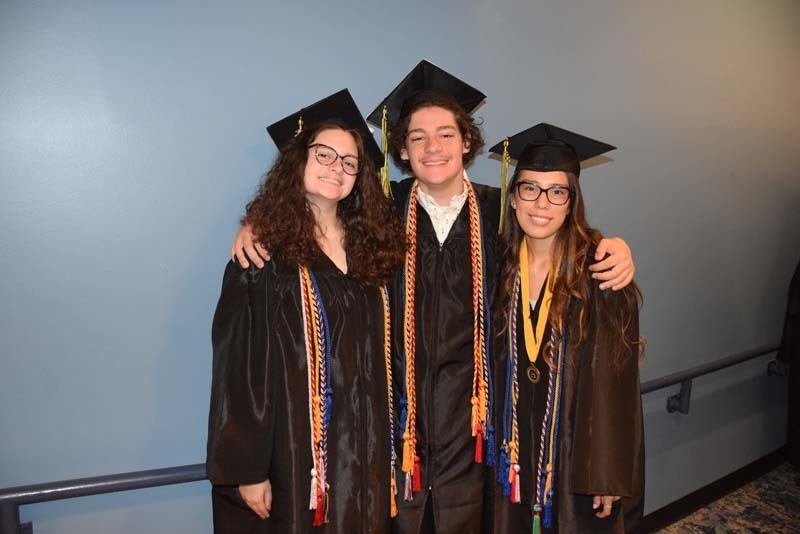 Graduates smiling at the camera