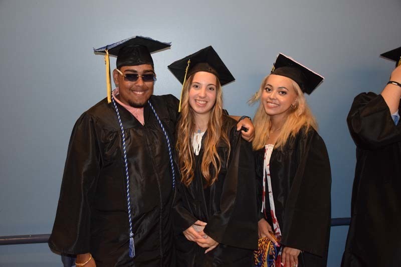 Graduates smiling at the camera