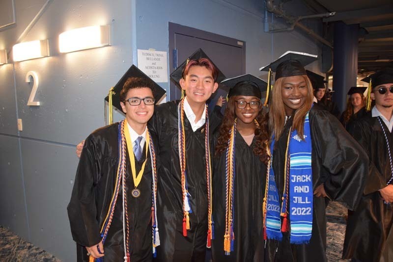 Graduates smiling at the camera