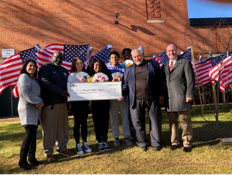 Students, Staff, and Veterans holding big check
